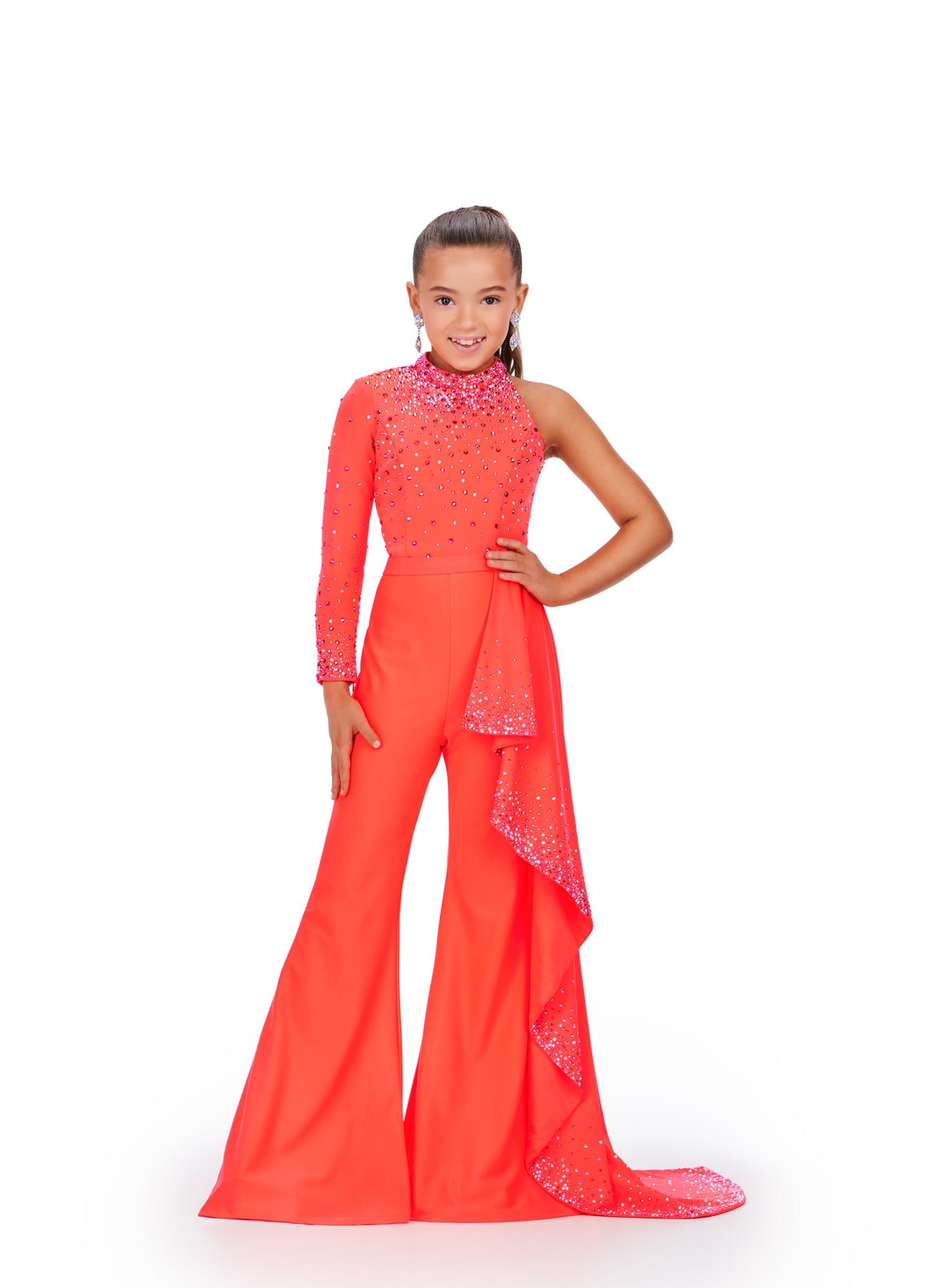 Presenting the Ashley Lauren Kids 8253 Girls Pageant Jumpsuit, featuring a stunning ruffle train and bell bottom pants. This elegant pant suit offers long sleeves for comfort and style, perfect for your little star's big moment. Elevate her confidence and charm on stage with this chic and timeless design. Bring the sass in this high neckline jumpsuit with one sleeve