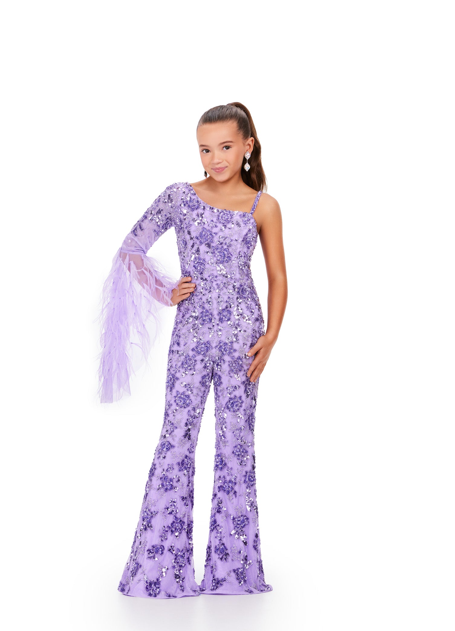 The Ashley Lauren Kids 8268 Girls Beaded Pageant Jumpsuit is a must-have for any fashion-forward young lady. Adorned with intricate beadwork and featuring dramatic feather bell sleeves, this jumpsuit will make her feel like a true fashionista. Perfect for pageants or any special occasion, it's both stylish and fun. This one shoulder kids jumpsuit features an intricate bead pattern throughout. The look is complete with a bell-sleeve scattered with feathers.