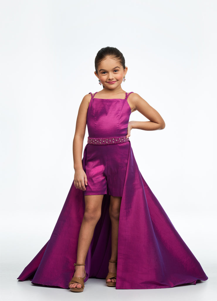 Ashley Lauren Kids 8131 Stretch Taffeta Romper Fun Fashion Overskirt Pageant Wear This stretch tafetta romper features a double spaghetti strap giving way to a beaded waistband. The look is completed with an attached overskirt. Double Spaghetti Strap Beaded Belt Romper Attached Overskirt Sizes: 2, 6, 8 Colors: Magenta