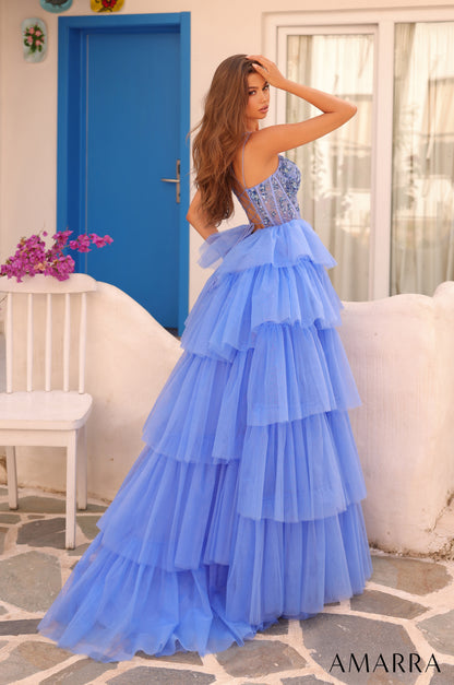 Experience luxury and elegance in the Amarra 88345 Ballgown. This stunning dress features sheer beaded corset detailing and layers of flowing fabric, creating a show-stopping look. Perfect for prom, pageants, or any formal event, this dress will make you feel like royalty.

Sizes: 000-16

Colors: Hot Pink,&nbsp;Ivory,&nbsp;Light Blue,&nbsp;Periwinkle,&nbsp;Red