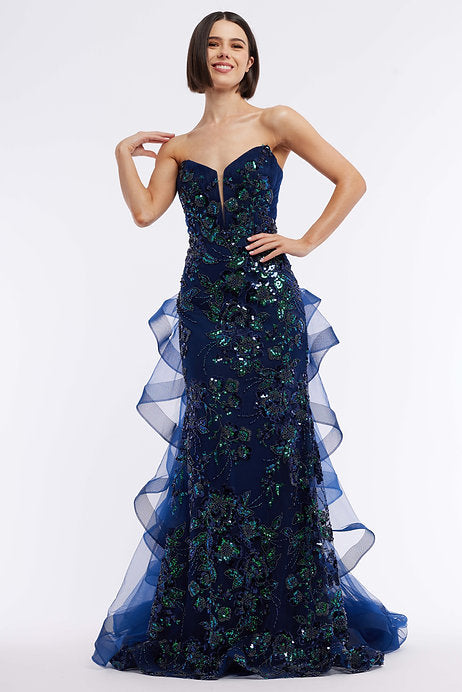 Experience elegance and glamour with the Vienna Prom 8866 Long Prom Dress. This stunning gown features a sequin bodice and layered ruffles, making you the center of attention at any formal event. The plunging neckline adds a touch of seduction while the flowing layers create a dreamy, feminine silhouette. Perfect for prom, pageants, or any special occasion.