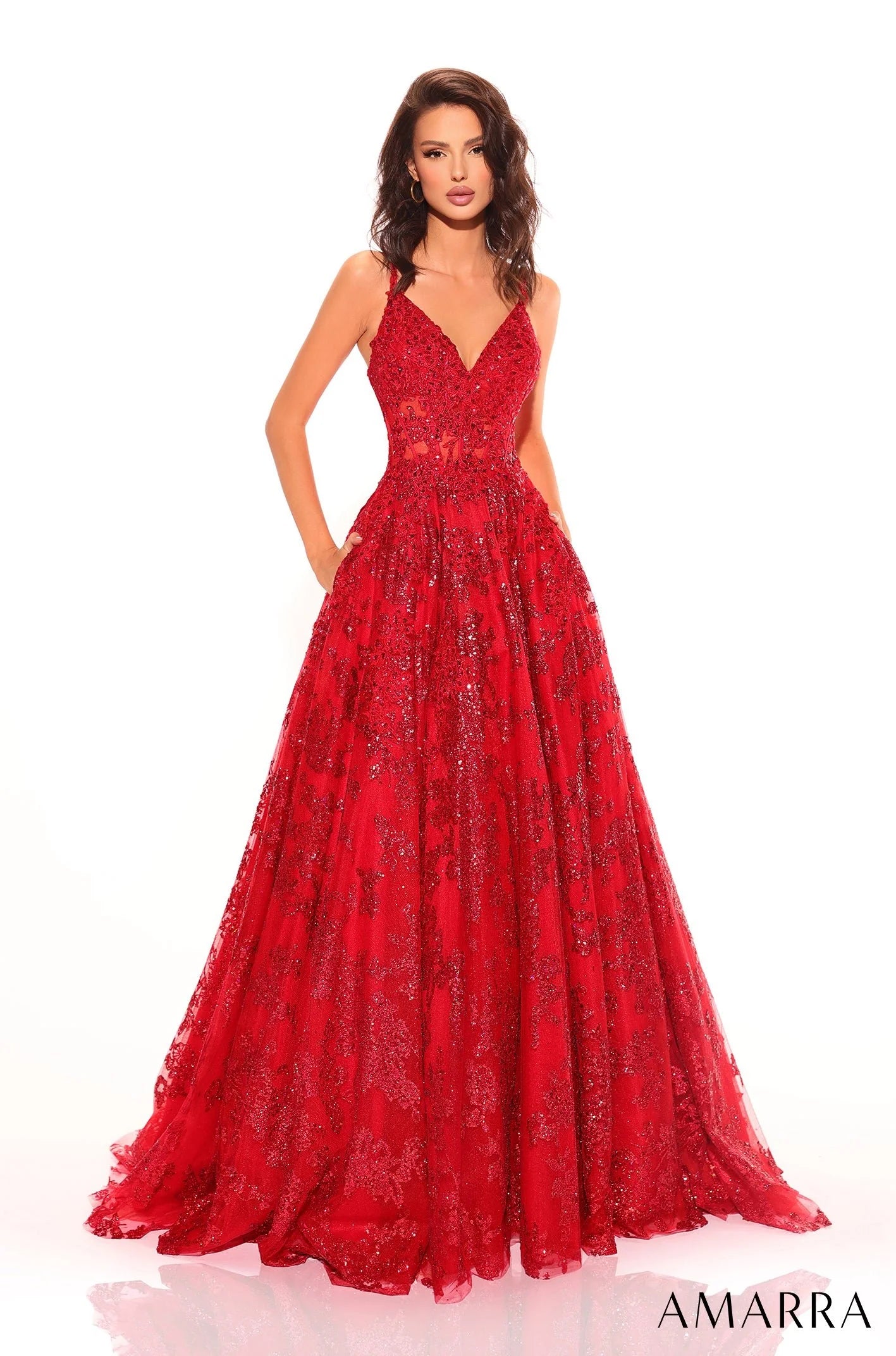 Amarra 88727 Behold this mesmerizing ball gown, a true enchantress among prom dresses. Its captivating design and undeniable charm will leave you breathless. Embellished with shimmering tulle and exquisite three-dimensional floral details, this gown is a true beauty! The sweetheart neckline and delicate spaghetti straps gracefully enhance your silhouette, while the stunning strappy back adds an extra touch of elegance. 