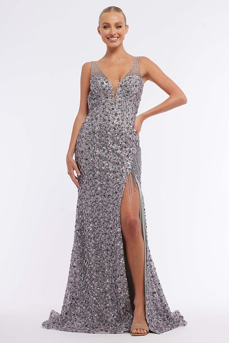 This Vienna Prom 8875 long prom dress is a stunning choice for your formal event. With a fitted silhouette, sequin detailing, and a sheer open back, it exudes elegance and sophistication. The slit adds a touch of glamour, making you feel confident and beautiful. Perfect for prom or a pageant.