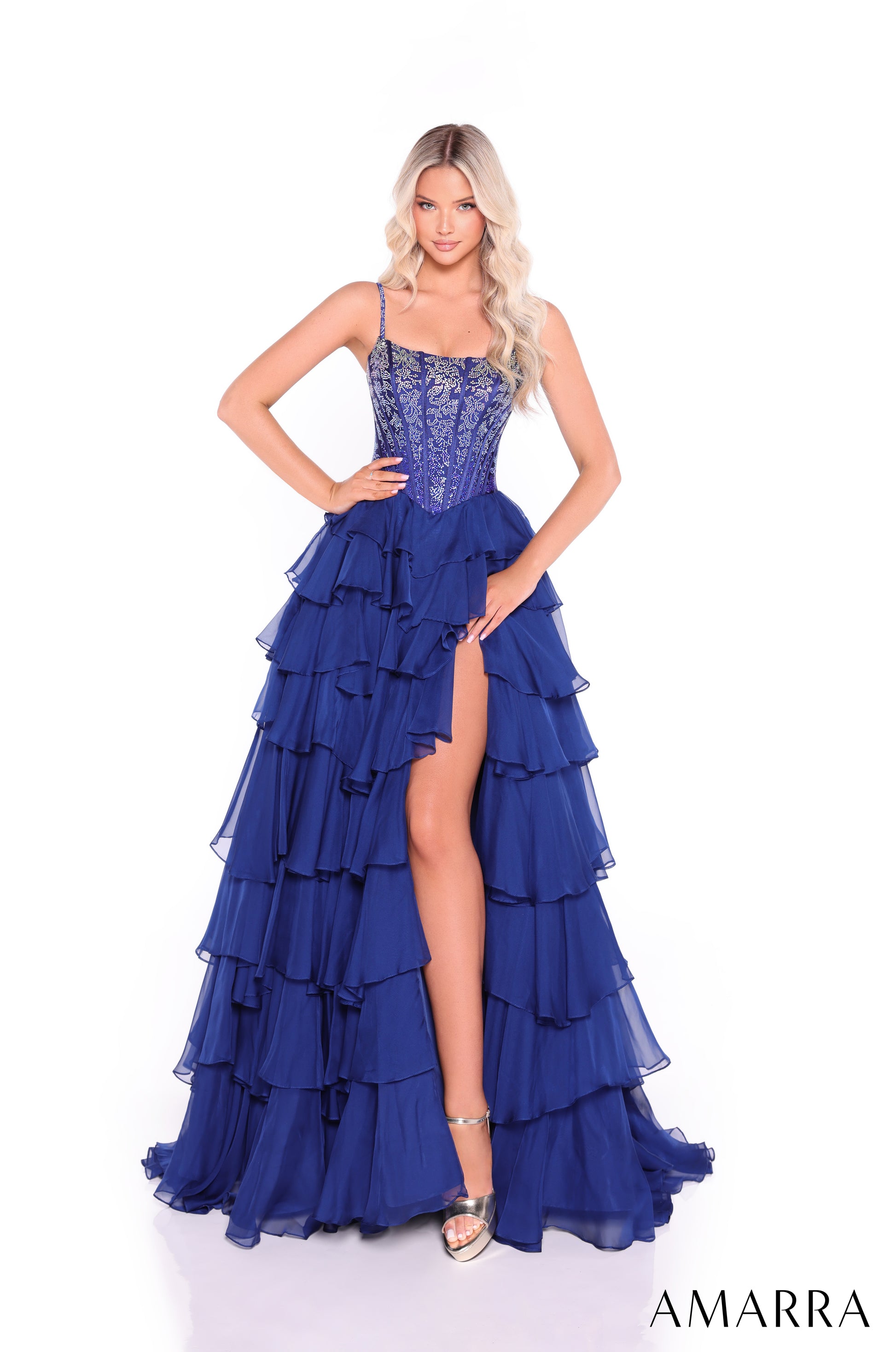 Make a stunning entrance in this Amarra 89459 prom dress, featuring an elegantly structured lace-up corset bodice with a flattering scoop neckline. The voluminous A-line silhouette showcases dramatic layered ruffles throughout the skirt, while a daring slit adds movement and sophistication. This formal gown combines classic corsetry with contemporary design, creating a show-stopping look perfect for prom night or any formal occasion.

Sizes: 000-22

Colors: Black,&nbsp;Bright Pink,&nbsp;Navy,&nbsp;Royal Blu