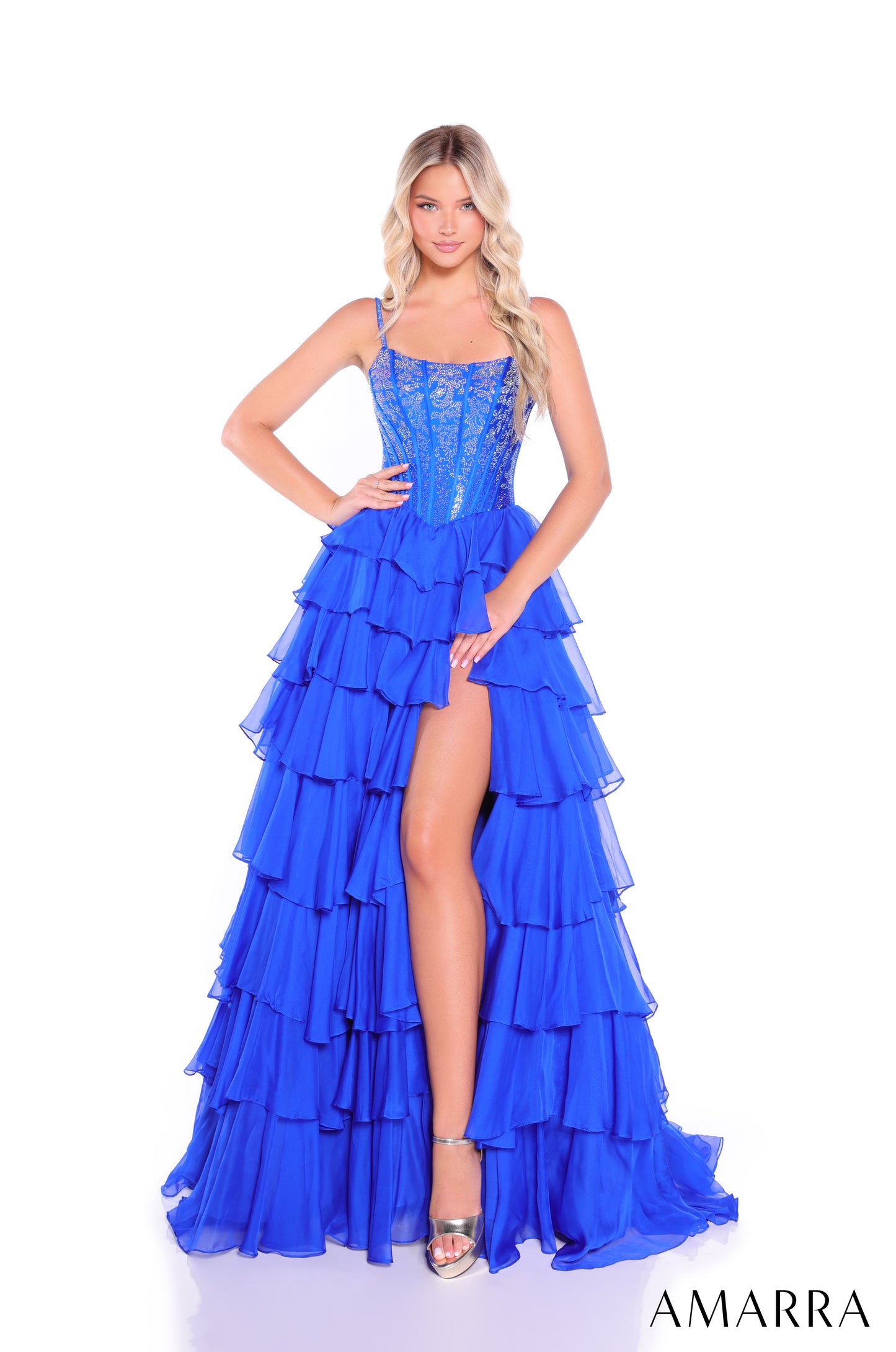 Make a stunning entrance in this Amarra 89459 prom dress, featuring an elegantly structured lace-up corset bodice with a flattering scoop neckline. The voluminous A-line silhouette showcases dramatic layered ruffles throughout the skirt, while a daring slit adds movement and sophistication. This formal gown combines classic corsetry with contemporary design, creating a show-stopping look perfect for prom night or any formal occasion.

Sizes: 000-22

Colors: Black,&nbsp;Bright Pink,&nbsp;Navy,&nbsp;Royal Blu