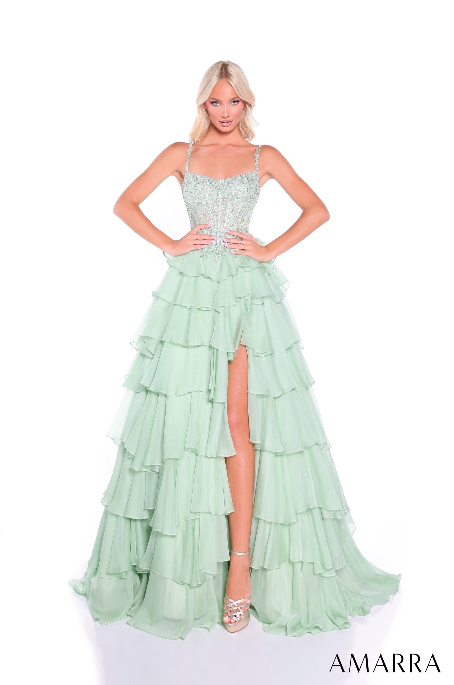 Make a stunning entrance in this Amarra 89507 prom dress, featuring an elegant sheer lace scoop neckline and structured basque waist corset that flatters your silhouette. The dramatic ruffle layered skirt adds movement and dimension, while the front slit provides both sophistication and ease of movement. Crafted with intricate lace detailing throughout, this dress combines timeless elegance with contemporary design—perfect for prom, formal events, or special occasions where you want to command attention.

S