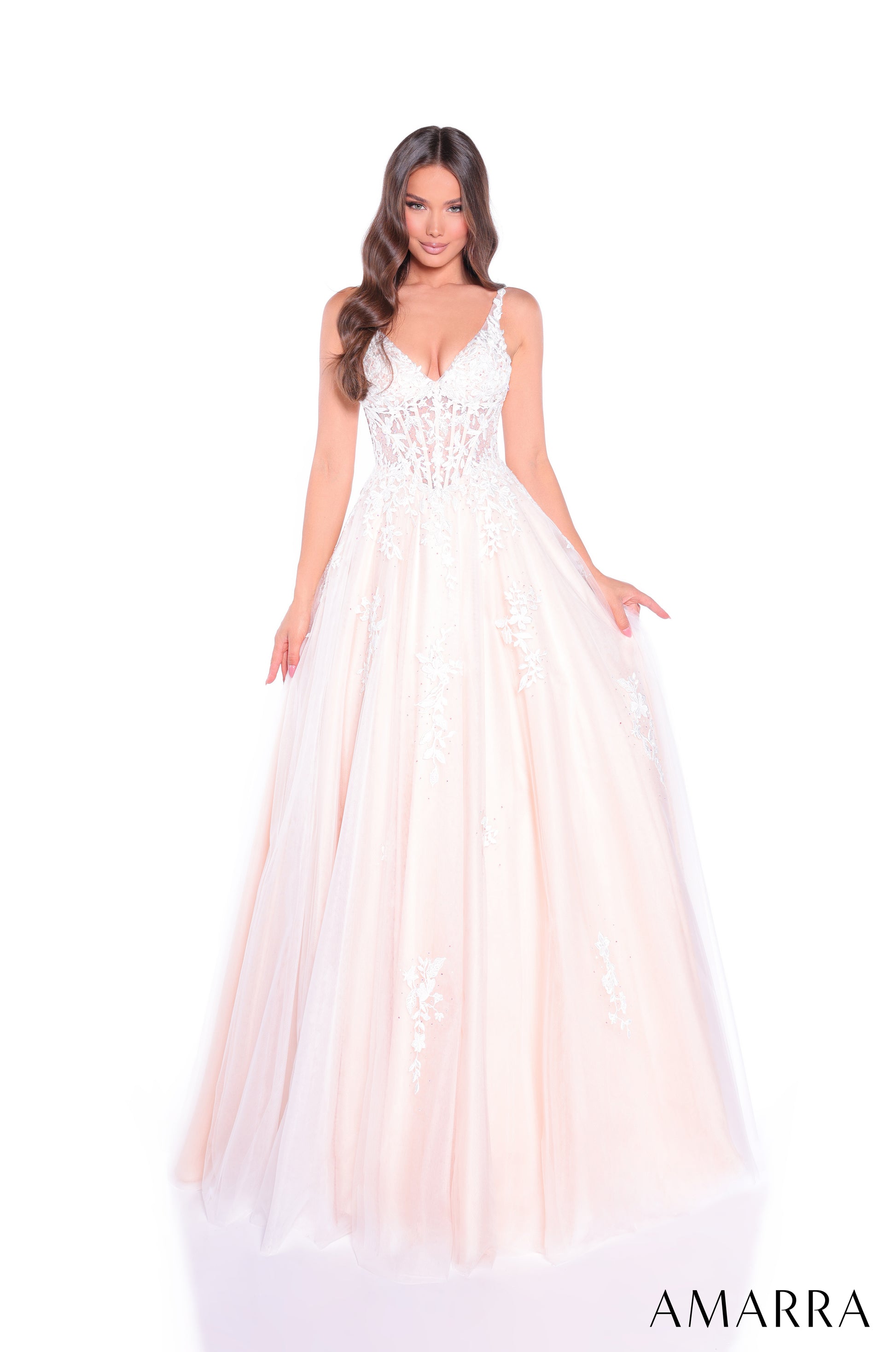 Amarra's 89523 presents an elegant ballgown silhouette designed for the discerning prom attendee. The sheer lace corset bodice creates a sophisticated foundation, while the voluminous A-line tulle skirt delivers the dramatic presence expected of formal wear. The V-neckline offers a flattering frame that balances the gown's generous volume. This dress combines structured bodice support with flowing skirt movement, making it suitable for extended wear throughout the evening. The intricate lace detailing adds 