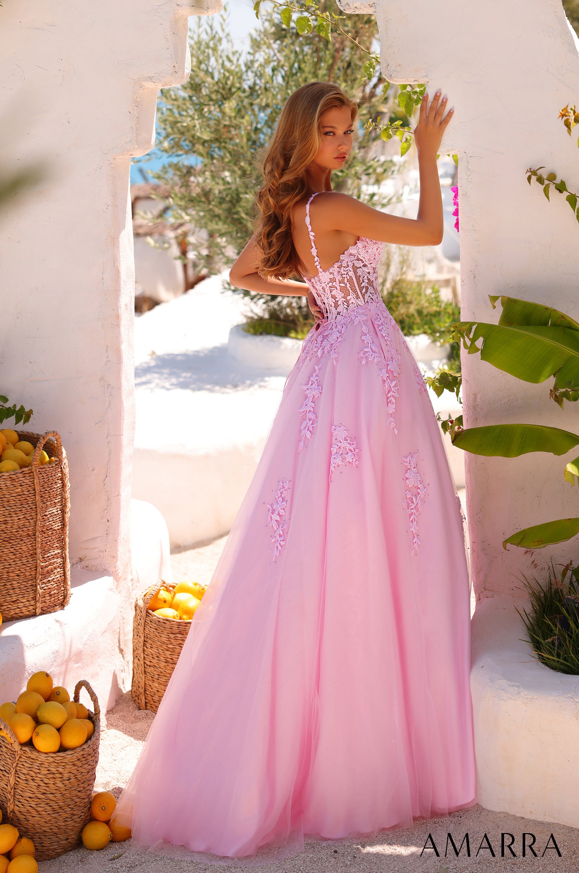 Amarra's 89523 presents an elegant ballgown silhouette designed for the discerning prom attendee. The sheer lace corset bodice creates a sophisticated foundation, while the voluminous A-line tulle skirt delivers the dramatic presence expected of formal wear. The V-neckline offers a flattering frame that balances the gown's generous volume. This dress combines structured bodice support with flowing skirt movement, making it suitable for extended wear throughout the evening. The intricate lace detailing adds 