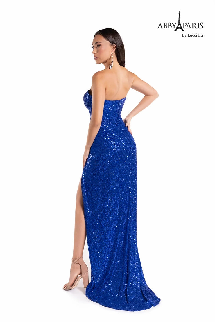 Look dazzling in Abby Paris' 90160 prom dress. This fit and flare style flatters the figure and features a sweetheart neckline and sequin embellishment. The slit and long hemline make this dress perfect for your next special event.