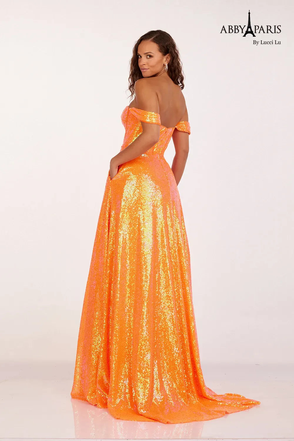 This Abby Paris Prom Dress features a timeless off-the-shoulder design with a flattering corset bodice. The dress is adorned with stunning sequins, adding a touch of glamour to any formal occasion. With convenient pockets, you'll have a place to store your essentials while dancing the night away. Feel confident and elegant in this stylish ballgown.&nbsp;