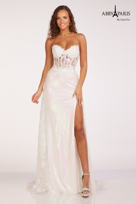 Impress in this Abby Paris 90229 Sheer Corset Sequin Prom Dress. The sheer corset accentuates your figure while the overskirt adds a touch of elegance. Sparkling sequins and a thigh-high slit make this the perfect pageant gown. Stand out with 100% confidence and sophistication.  Size: 8  Color: White
