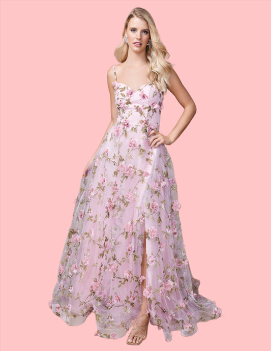 Expertly designed for a sophisticated look, the Nina Canacci 9150 Maxi Dress is the perfect choice for prom or any formal event. This stunning A-line gown features a floral print, 3D detailing, and a V-neckline that will flatter any figure. With a dramatic slit, you'll make a statement as you dance the night away.