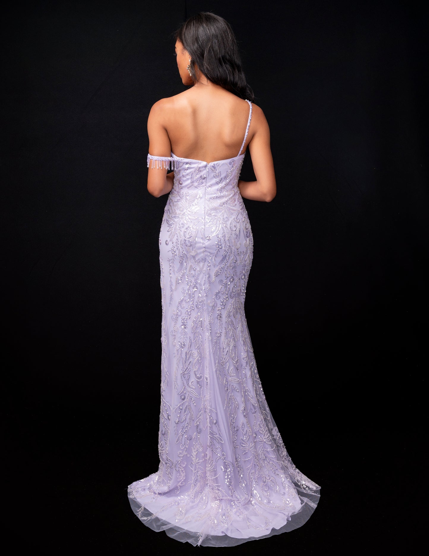 <p data-mce-fragment="1">Effortlessly stun in the Nina Canacci 9160 evening gown. This one-shoulder dress features a sheer sequin design, with a beaded fringe slit for added elegance. The off-the-shoulder style adds a touch of sophistication to this formal dress. Perfect for any special occasion, this dress is sure to make a statement.</p> <p data-mce-fragment="1">Sizes: 2-14</p> <p data-mce-fragment="1">Colors: Purple</p>