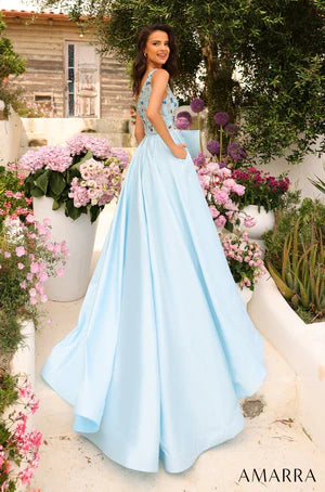Amarra 94041 This dress is the pure definition of go big or go home, or in this case, go big at prom or stay home. The fitted bodice with one shoulder is splendidly resplendent with rhinestone crystals of various intriguing colors - blue, red, light yellow, green, orange - beaded into the linen. This dazzling bodice seamlessly transitions into a silken tulle skirt that flows down the floor in one graceful wave and a big gorgeous bow sits on the waistline, accentuating the glamorous look.