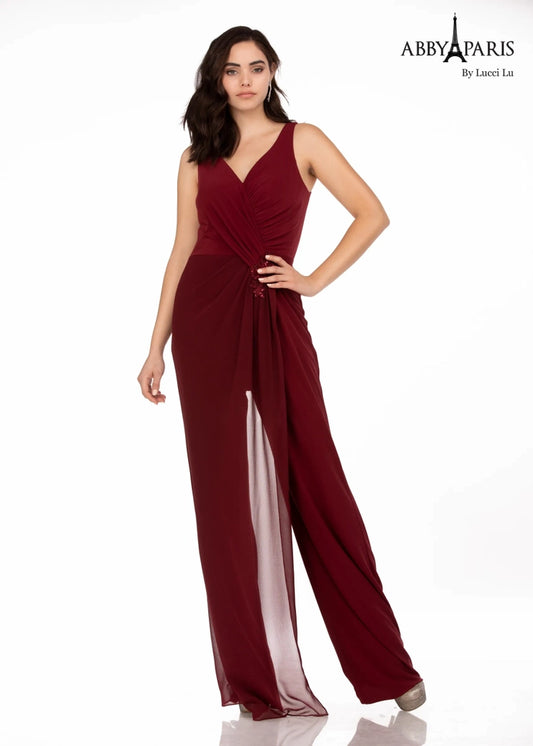 Make an unforgettable entrance in this Abby Paris 96064 jumpsuit. With an elegant v-neck bodice, ruching, and a sheer cape, this piece is designed to enhance your curves, while keeping you comfortable. A classic look that's perfect for any special occasion.