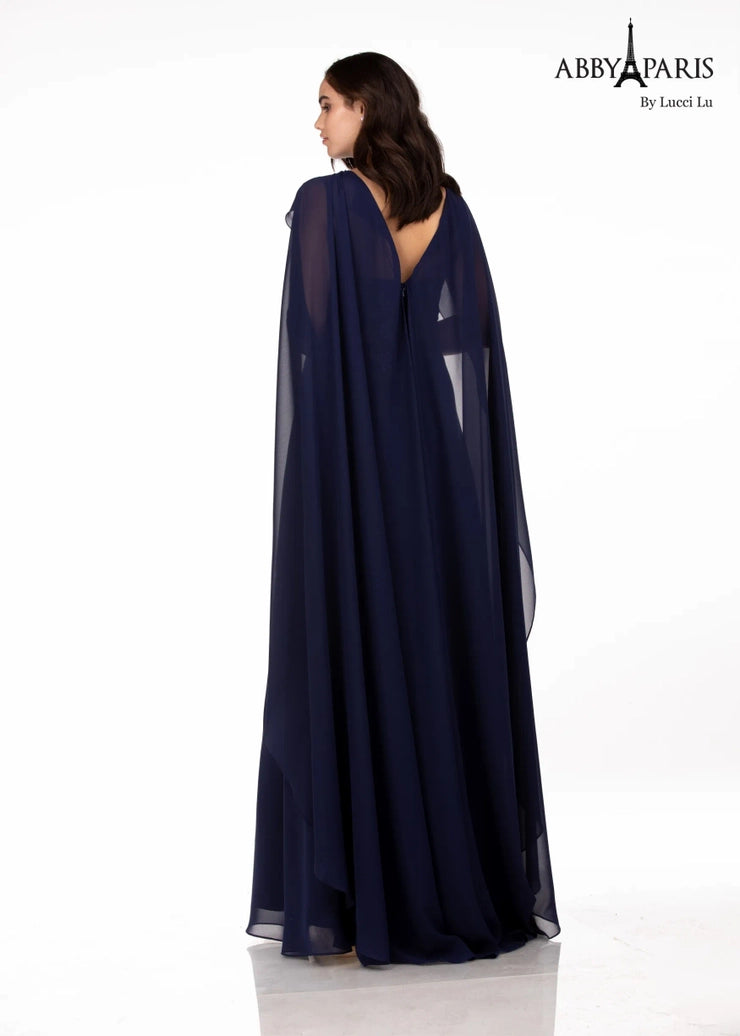 Abby Paris 96067 A-Line Embellished Bodice Sheer Cape V-Back High Neck MOB Formal Gown. The Abby Paris 96067 Gown boasts a timeless and elegant A-Line silhouette that will flatter any figure. The embellished bodice and sheer cape add a hint of sparkle, while the high neck and V-Back give a striking look. Perfect for any formal event.