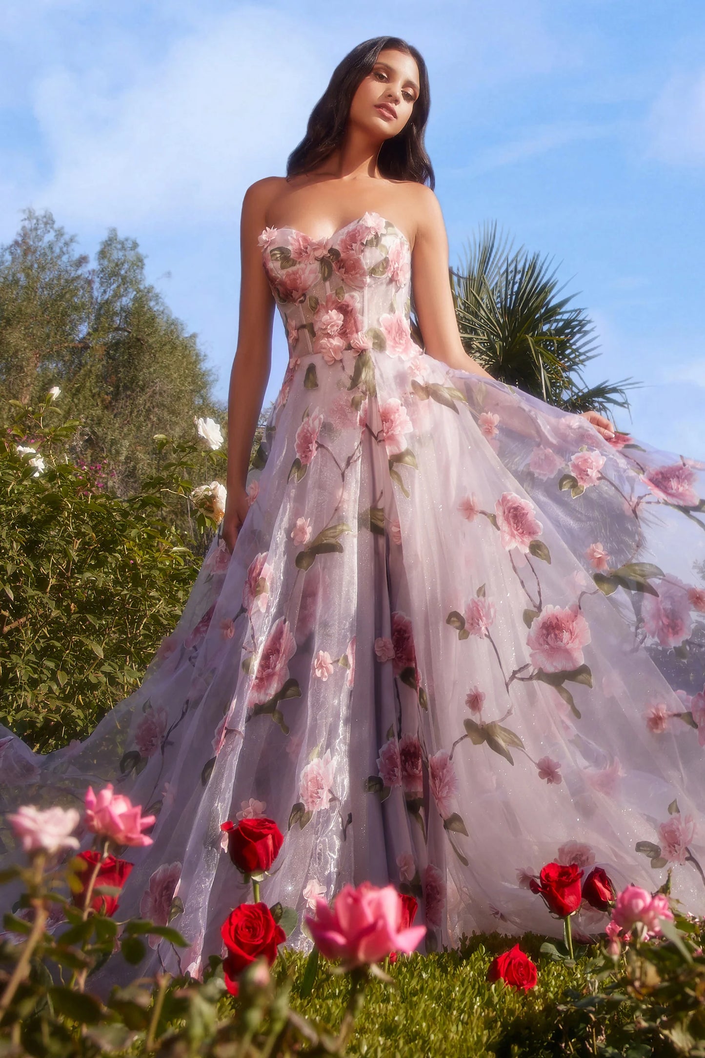 Andrea & Leo Couture A1035  Welcome to the fairytale world of magic and enchantment in this breathtaking A-line gown. This best selling gown is crafted from luxe Organza fabric, showing off an array of dimensional floral appliques and pink rose print. The strapless bodice features a sheer corset design, flaunting an ethereal blushing pink hue beneath a flourish of intricate roses and petals along the body. And