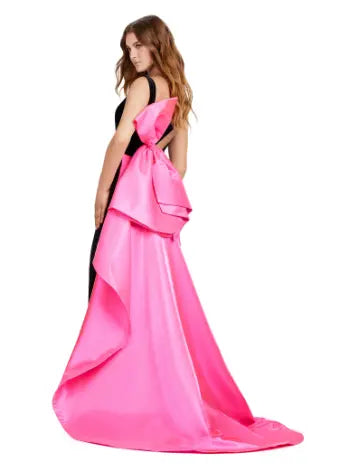 This Ashely Lauren 11527 Long Prom Dress is designed with a fitted V neckline, satin bow detailing, and a stunning open back. Its side skirt adds an elegant touch, perfect for formal events or pageants. Crafted with quality fabric, this gown exudes both style and comfort. Who doesn't love a bow moment? This v-neckline velvet gown features an inverted oversized satin bow and sweep train.
