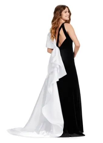 This Ashely Lauren 11527 Long Prom Dress is designed with a fitted V neckline, satin bow detailing, and a stunning open back. Its side skirt adds an elegant touch, perfect for formal events or pageants. Crafted with quality fabric, this gown exudes both style and comfort. Who doesn't love a bow moment? This v-neckline velvet gown features an inverted oversized satin bow and sweep train.