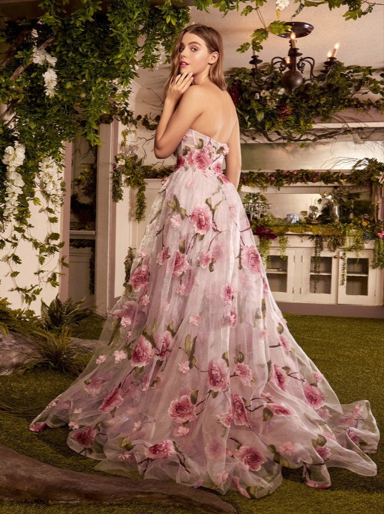 Andrea & Leo Couture A1035 Portrait of a Rose Printed Organza DressAndrea & Leo Couture A1035  Welcome to the fairytale world of magic and enchantment in this breathtaking A-line gown. This best selling gown is crafted from luxe Organza fabric, showing off an array of dimensional floral appliques and pink rose print. The strapless bodice features a sheer corset design, flaunting an ethereal blushing pink hue beneath a flourish of intricate roses and petals along the body. And
