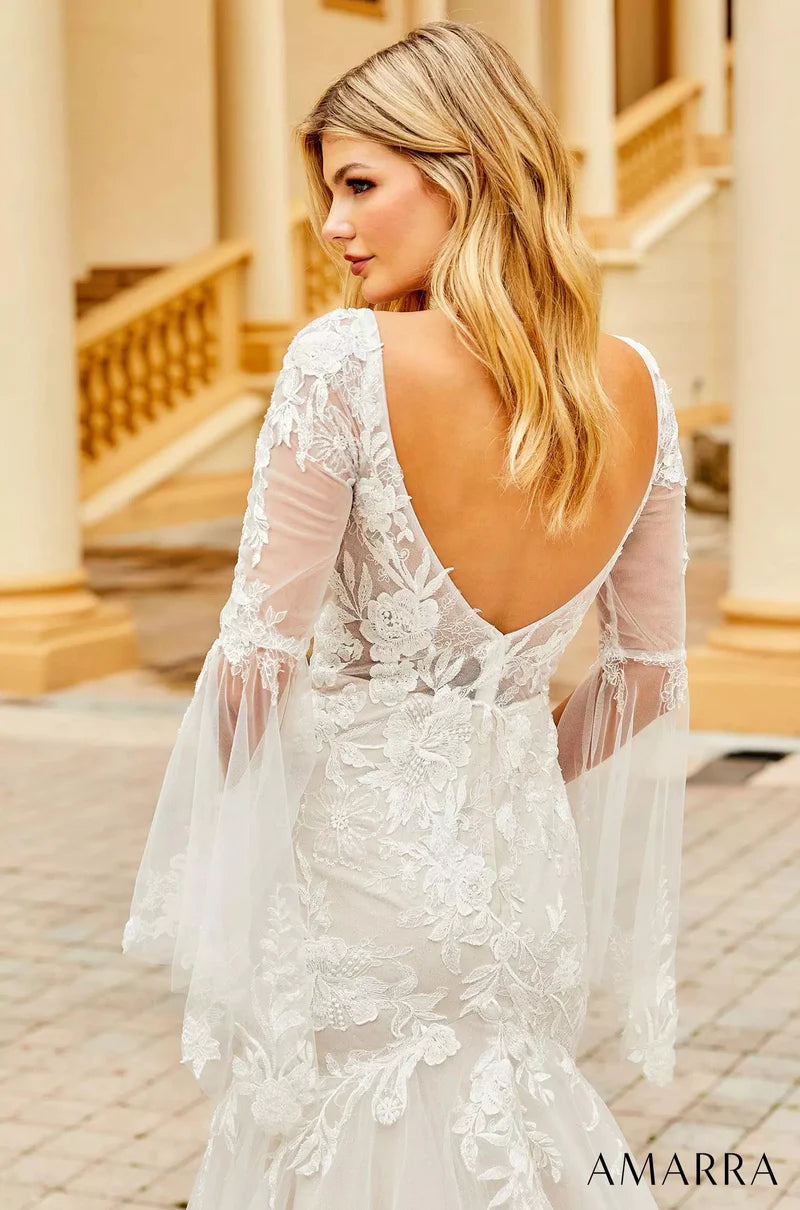 Amarra Bridal 84386 "Anna" Mermaid V-Neck Sheer Floral Long Sleeve Train Wedding Dress. If you’re looking for a wedding gown that shows some skin, but not too much, meet Anna. This captivating gown features a deep-v neckline and sheer sleeves that cover the arms, but still dare to show a little skin