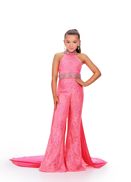 This Ashley Lauren Kids 8225 Girls Lace Crystal Jumpsuit Cape Bell Bottom Pageant Fun Fashion Wear is the perfect way to show off your sense of style. Its exquisite halter neckline and beaded accents make it a truly eye-catching piece. The chiffon cape and flare pant legs add a dramatic element and the jeweled belt and choker provide a touch of sparkle. Make a bold fashion statement with this beautiful jumpsuit!  Sizes: 16  Colors: Hot Pink 