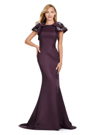 Elevate your evening look with the Ashley Lauren 11415 Wine Evening Gown Mermaid Dress. This stunning gown features a double-faced satin fabric and intricate bow detail, perfect for a formal event or pageant. Embrace timeless elegance and make a statement with this expertly crafted dress. Make an entrance in this double faced satin gown complete with bow shoulders and beaded details. in this memorable dress styled with radiant beading on the layered shoulder straps.