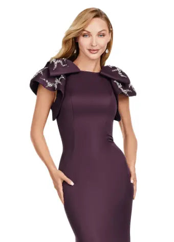 Elevate your evening look with the Ashley Lauren 11415 Wine Mermaid Dress. This stunning gown features a double-faced satin fabric and intricate bow detail, perfect for a formal event or pageant. Embrace timeless elegance and make a statement with this expertly crafted dress. Make an entrance in this double faced satin gown complete with bow shoulders and beaded details. in this memorable dress styled with radiant beading on the layered shoulder straps.