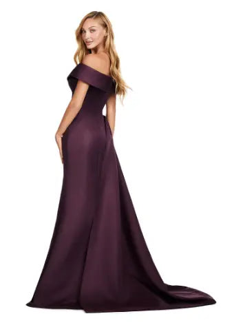 This Ashley Lauren 11425 Long Wine Evening Mother of Dress is the perfect choice for any formal occasion. The off-shoulder design adds a touch of elegance, while the fitted satin fabric hugs your figure for a flattering silhouette. The overskirt adds a dramatic flare, making you feel like a pageant queen. Elevate your style with this versatile and stunning dress. An elegant off the shoulder neckline drapes the shoulders in elegant evening gown. The look is complete with beaded details and a side overskirt.