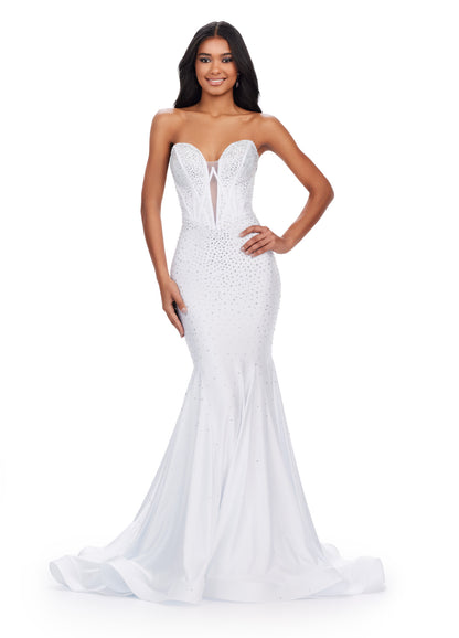 This elegant Ashley Lauren 11560 prom dress features a strapless neckline, fitted jersey fabric, and a mermaid silhouette that will accentuate your figure. The V-neck adds a touch of sophistication to this formal gown, making it perfect for prom or a pageant. Feel confident and beautiful in this stunning dress. This classic strapless jersey gown features a fully beaded corset bustier. The press on stones make this extra glamourous.