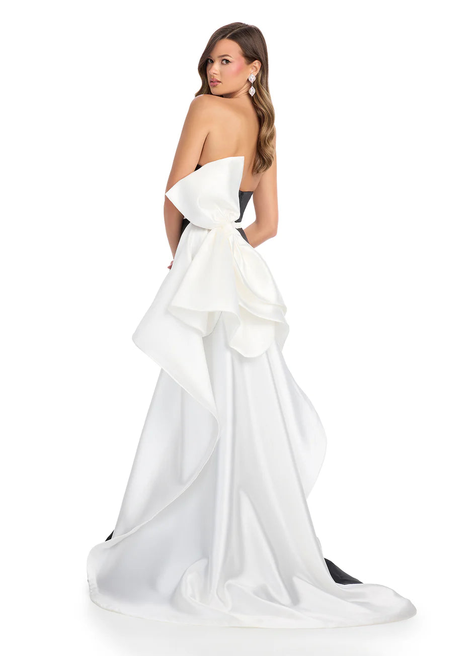 Ashley Lauren 11866 Mikado Strapless Gown With Bow.&nbsp; We love a bow! This strapless mikado gown features a belt and left leg slit. The look is complete with a back bow that cascades down the back and onto the sweep train.

Strapless
Mikado
Left Leg Slit
Ruffle Detail
Colors:&nbsp; Red, Yellow, Black/White, Pink, White