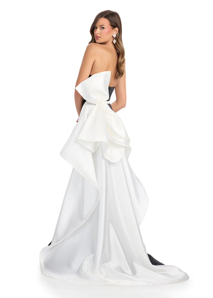 Ashley Lauren 11866 Mikado Strapless Gown With Bow.&nbsp; We love a bow! This strapless mikado gown features a belt and left leg slit. The look is complete with a back bow that cascades down the back and onto the sweep train.

Strapless
Mikado
Left Leg Slit
Ruffle Detail
Colors:&nbsp; Red, Yellow, Black/White, Pink, White