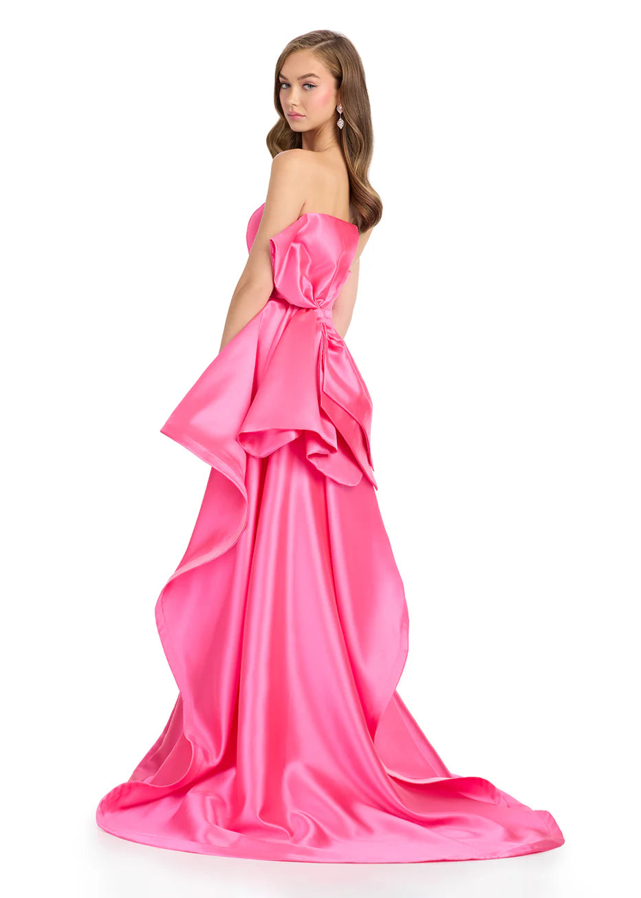 Ashley Lauren 11866 Mikado Strapless Gown With Bow.&nbsp; We love a bow! This strapless mikado gown features a belt and left leg slit. The look is complete with a back bow that cascades down the back and onto the sweep train.

Strapless
Mikado
Left Leg Slit
Ruffle Detail
Colors:&nbsp; Red, Yellow, Black/White, Pink, White