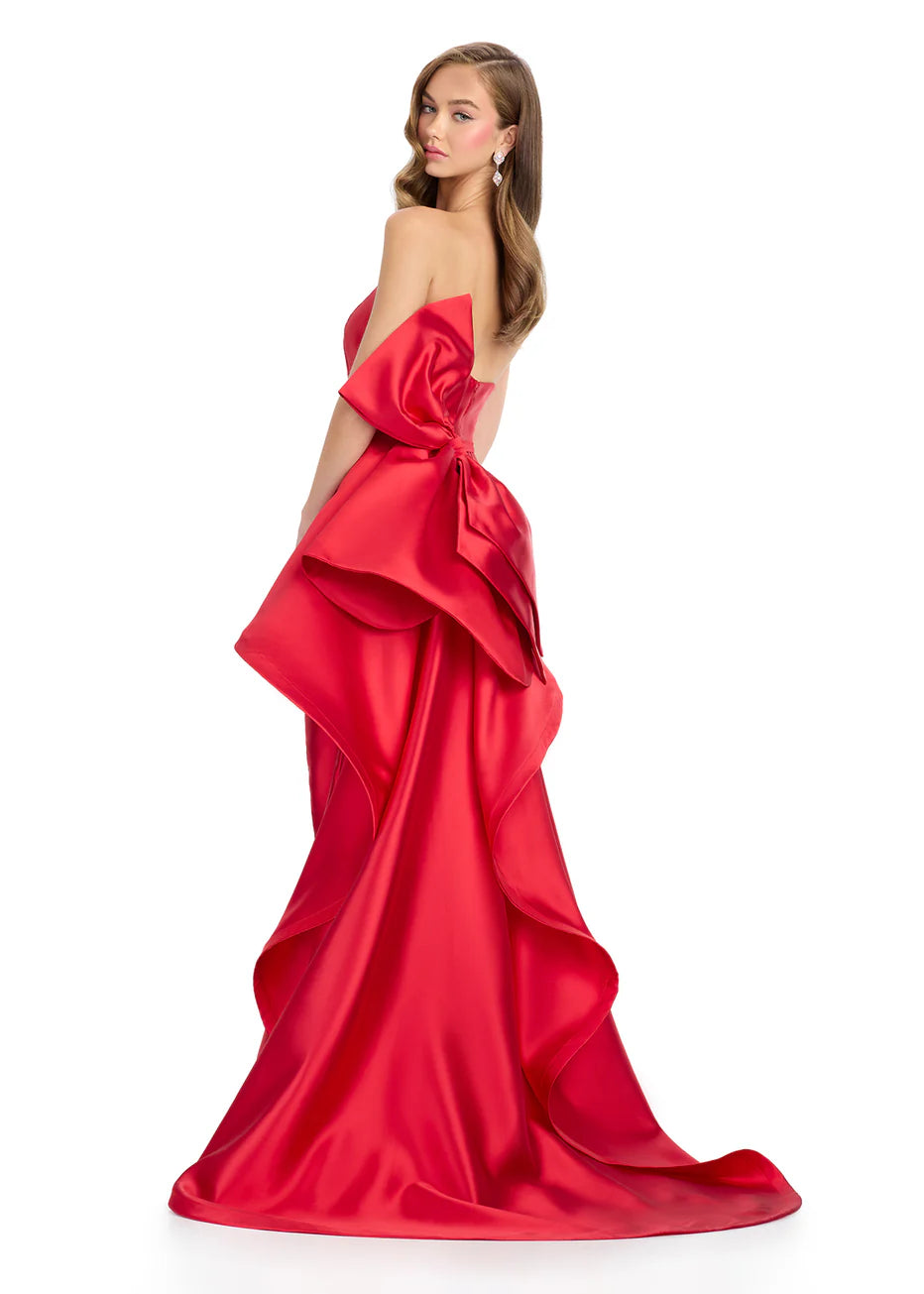 Ashley Lauren 11866 Mikado Strapless Gown With Bow.&nbsp; We love a bow! This strapless mikado gown features a belt and left leg slit. The look is complete with a back bow that cascades down the back and onto the sweep train.

Strapless
Mikado
Left Leg Slit
Ruffle Detail
Colors:&nbsp; Red, Yellow, Black/White, Pink, White