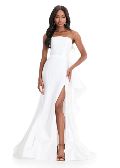 Ashley Lauren 11866 Mikado Strapless Gown With Bow.&nbsp; We love a bow! This strapless mikado gown features a belt and left leg slit. The look is complete with a back bow that cascades down the back and onto the sweep train.

Strapless
Mikado
Left Leg Slit
Ruffle Detail
Colors:&nbsp; Red, Yellow, Black/White, Pink, White