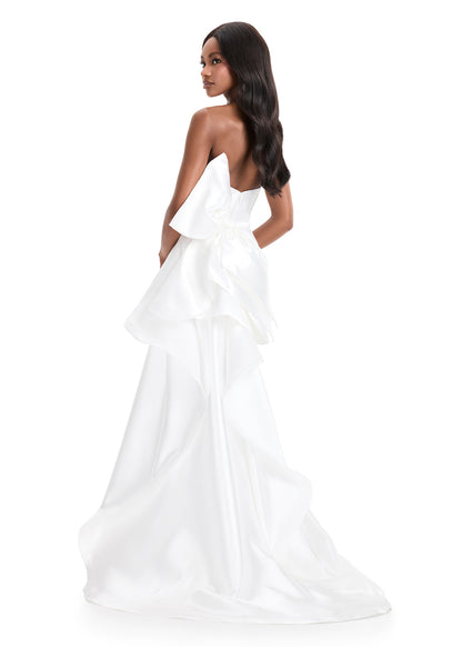 Ashley Lauren 11866 Mikado Strapless Gown With Bow.&nbsp; We love a bow! This strapless mikado gown features a belt and left leg slit. The look is complete with a back bow that cascades down the back and onto the sweep train.

Strapless
Mikado
Left Leg Slit
Ruffle Detail
Colors:&nbsp; Red, Yellow, Black/White, Pink, White