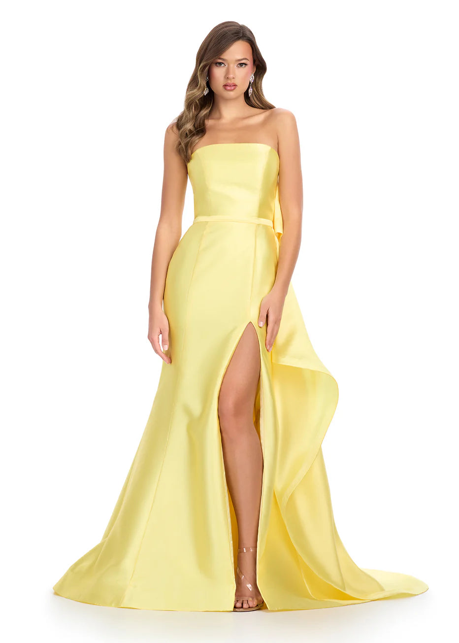 Ashley Lauren 11866 Mikado Strapless Gown With Bow.&nbsp; We love a bow! This strapless mikado gown features a belt and left leg slit. The look is complete with a back bow that cascades down the back and onto the sweep train.

Strapless
Mikado
Left Leg Slit
Ruffle Detail
Colors:&nbsp; Red, Yellow, Black/White, Pink, White