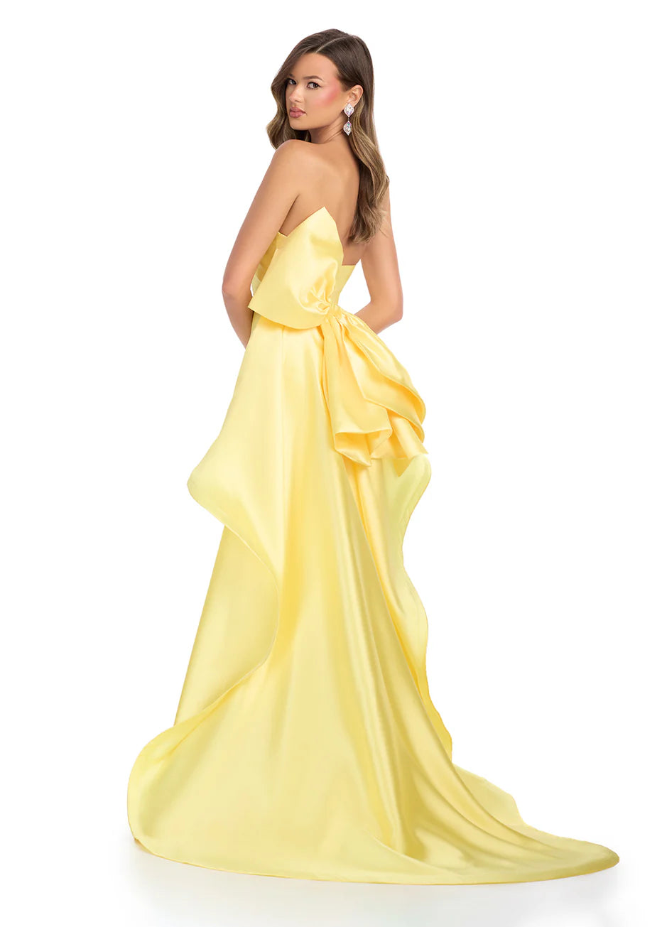 Ashley Lauren 11866 Mikado Strapless Gown With Bow.&nbsp; We love a bow! This strapless mikado gown features a belt and left leg slit. The look is complete with a back bow that cascades down the back and onto the sweep train.

Strapless
Mikado
Left Leg Slit
Ruffle Detail
Colors:&nbsp; Red, Yellow, Black/White, Pink, White