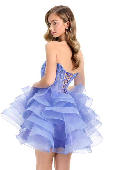 Elevate your evening with the Ashley Lauren 4883, a short fit-and-flare cocktail gown featuring delicate ruffle layers and a sheer corset bodice. This homecoming dress combines elegance and modern design, offering a flattering silhouette that enhances your natural shape. Perfect for special occasions, its intricate details and graceful flow ensure you stand out with timeless sophistication. Make a statement in this stunning ASHLEYlauren Style 4883 mini dress. Featuring a fully boned corset-style bodice with