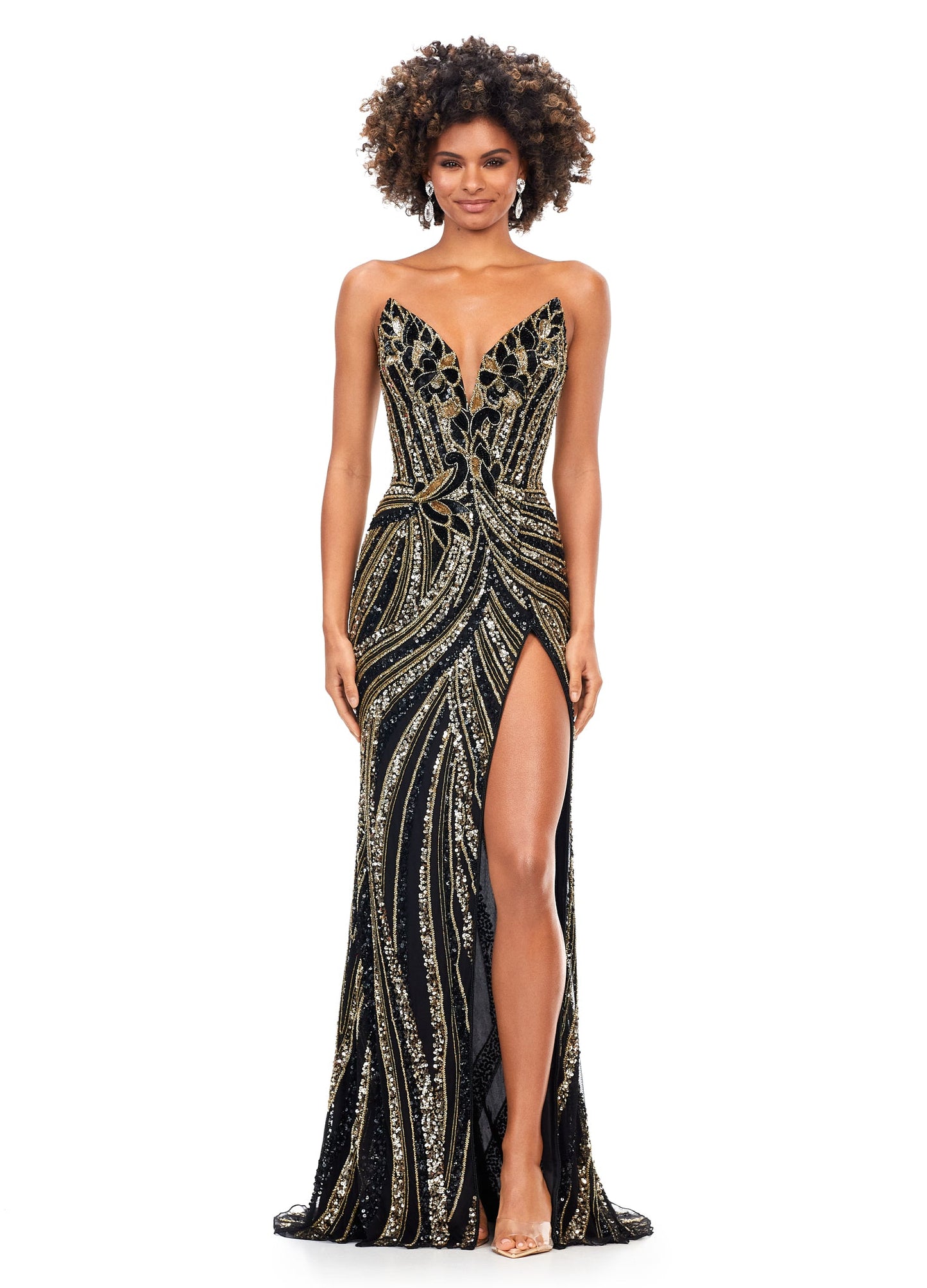 Ashley Lauren 11236 Black Gold Gown Long Fitted V Neck Slit Beaded Sequin Prom Dress Pageant Gown This strapless gown is sure to turn heads. The sweetheart neckline is complete with a modern floral sequin motif that continues down the bustier and skirt. The skirt is complete with a left leg slit. Strapless Bustier Left Leg Slit Fully Hand Beaded 