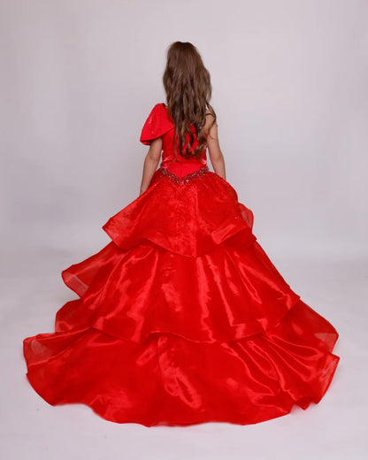 The Ava Presley Girls 39891 Long Pageant Ball Gown is a stunning formal dress designed with a one shoulder style and elegant ruffle details. The drop waist accentuates the silhouette and the layered skirt adds a touch of charm. Perfect for any special occasion, this gown exudes sophistication and grace. Turn heads in this Ava Presley 39891