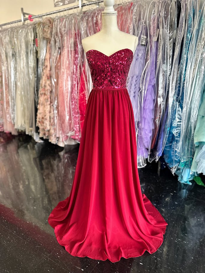 This Envious Couture BM170 dress in size 12 features a sophisticated burgundy hue, perfect for proms and bridesmaid occasions. Crafted from lightweight chiffon, it offers graceful movement and comfort throughout your event. The gown's flattering A-line silhouette and sparkling sequin accents create an elegant and timeless look that enhances your natural shape with subtle shine. Ideal for formal settings, this dress blends refined style with expert design tailored for memorable evenings.

Size: 12

Color: Bu