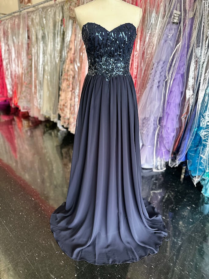 The Envious Couture BM196 in a Size 8 features a sophisticated navy chiffon fabric that flows beautifully in an A-line silhouette, ideal for bridesmaids and formal occasions. Adorned with subtle sequins, this long dress adds a refined sparkle without overwhelming the design. Its breathable chiffon ensures comfort throughout your event, while the classic cut flatters various body types, making it a reliable and stylish choice for any formal celebration.

Size: 8

Color: Navy