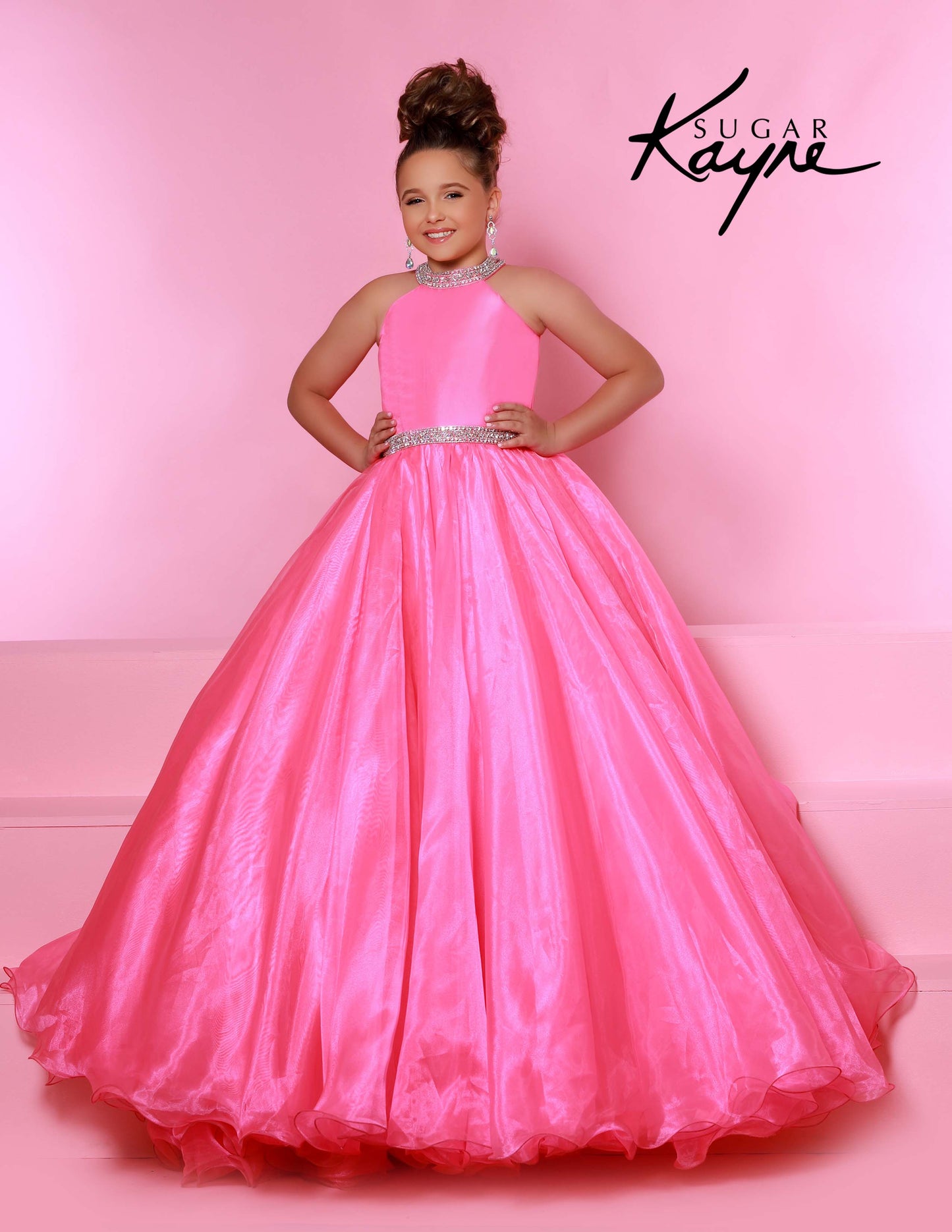 Sugar Kayne C114 by Johnathan Kayne is an Organza Girls Ball Gown Pageant Dress. Featuring a high neckline with crystal rhinestone accents. The waist line is broken with a crystal bling belt. The lush Ball gown skirt features a horse hair trim. Glide across the stage in the classic beauty!

Available Colors: Aqua, Barbie Pink, Jade, Lilac, Neon Orange, Royal, Ruby Red, White, Yellow
Available Size: 2-16

(Sizes 2-6 do not have bust cups, Sizes 8-16 will have preteen size bust cups)