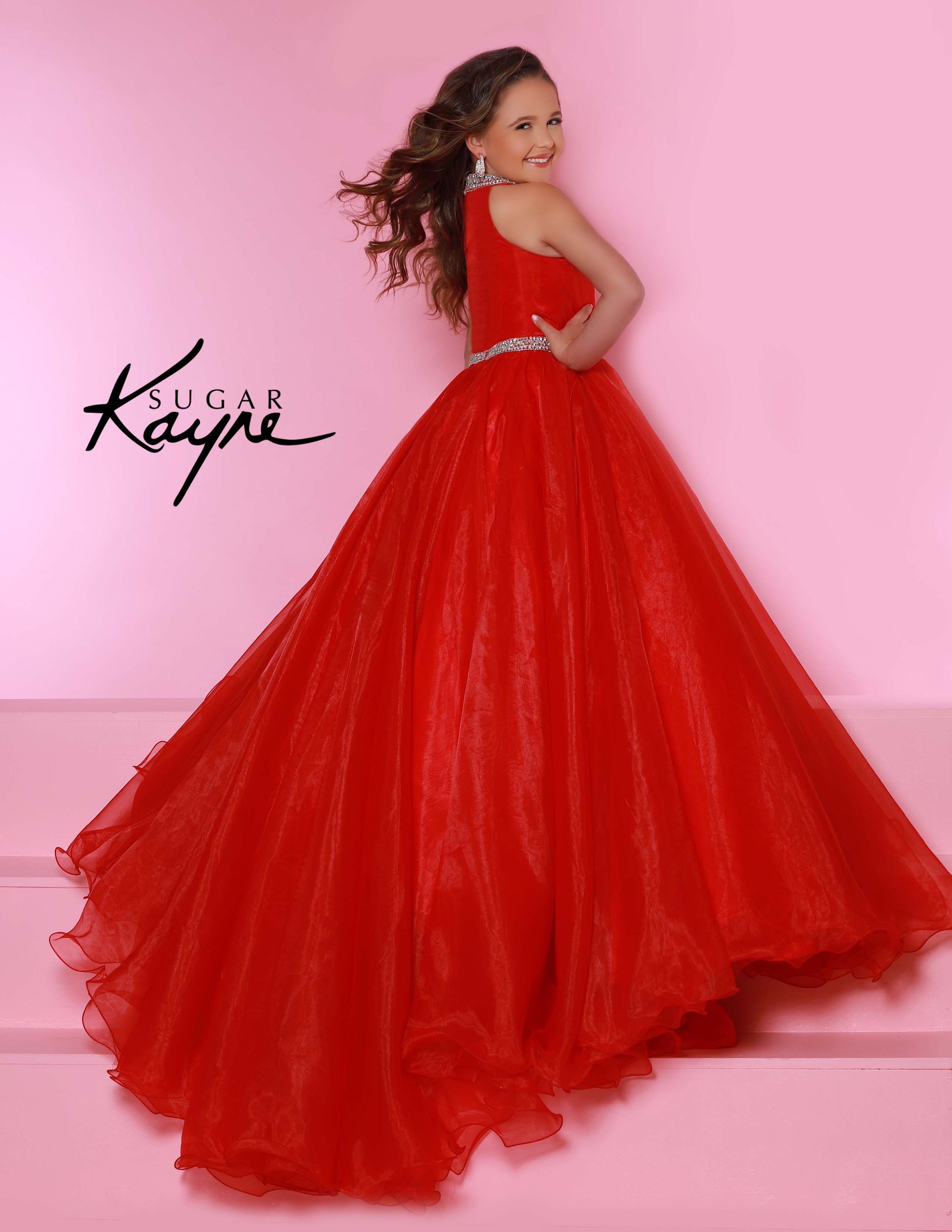 Sugar Kayne C114 by Johnathan Kayne is an Organza Girls Ball Gown Pageant Dress. Featuring a high neckline with crystal rhinestone accents. The waist line is broken with a crystal bling belt. The lush Ball gown skirt features a horse hair trim. Glide across the stage in the classic beauty!

Available Colors: Aqua, Barbie Pink, Jade, Lilac, Neon Orange, Royal, Ruby Red, White, Yellow
Available Size: 2-16

(Sizes 2-6 do not have bust cups, Sizes 8-16 will have preteen size bust cups)