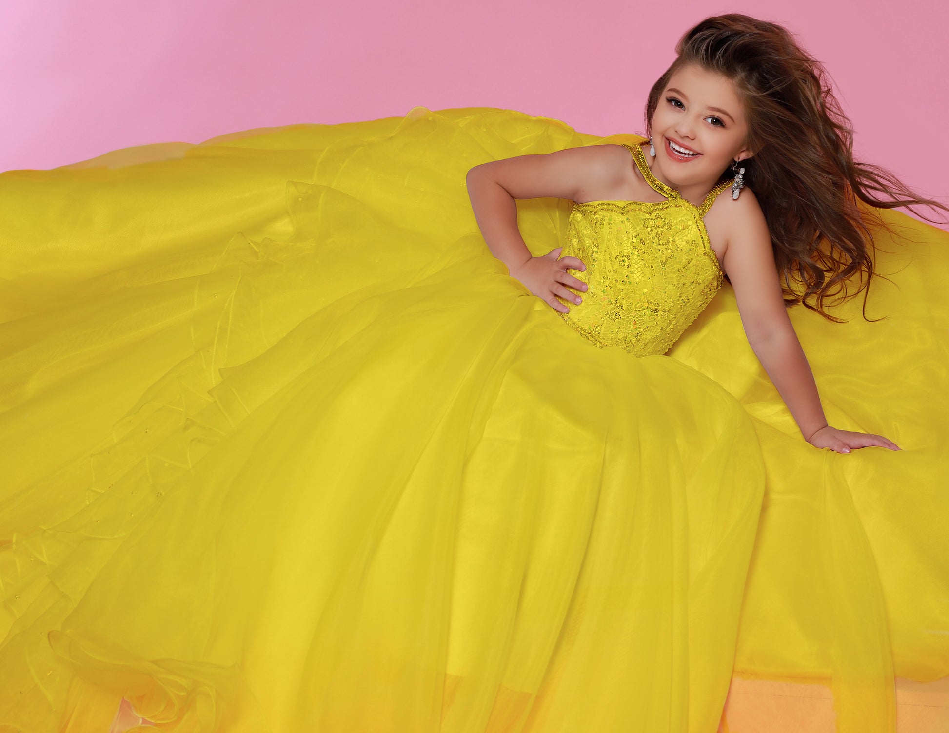 Sugar Kayne C143 Girls and Preteens Pageant Dress.&nbsp; This is a beautiful flowy organza pageant gown with embellished high neckline.&nbsp; This dress features an organza ruffle that flows down the back of the dress.

Colors: &nbsp;Hot Pink, Magenta, Red, Royal, White, Yellow

Sizes:&nbsp; 2-16

(Sizes 2-6 do not have bust cups, Sizes 8-16 will have preteen size bust cups)

Fabric:&nbsp; Satin, Organza, Stretch Lace
