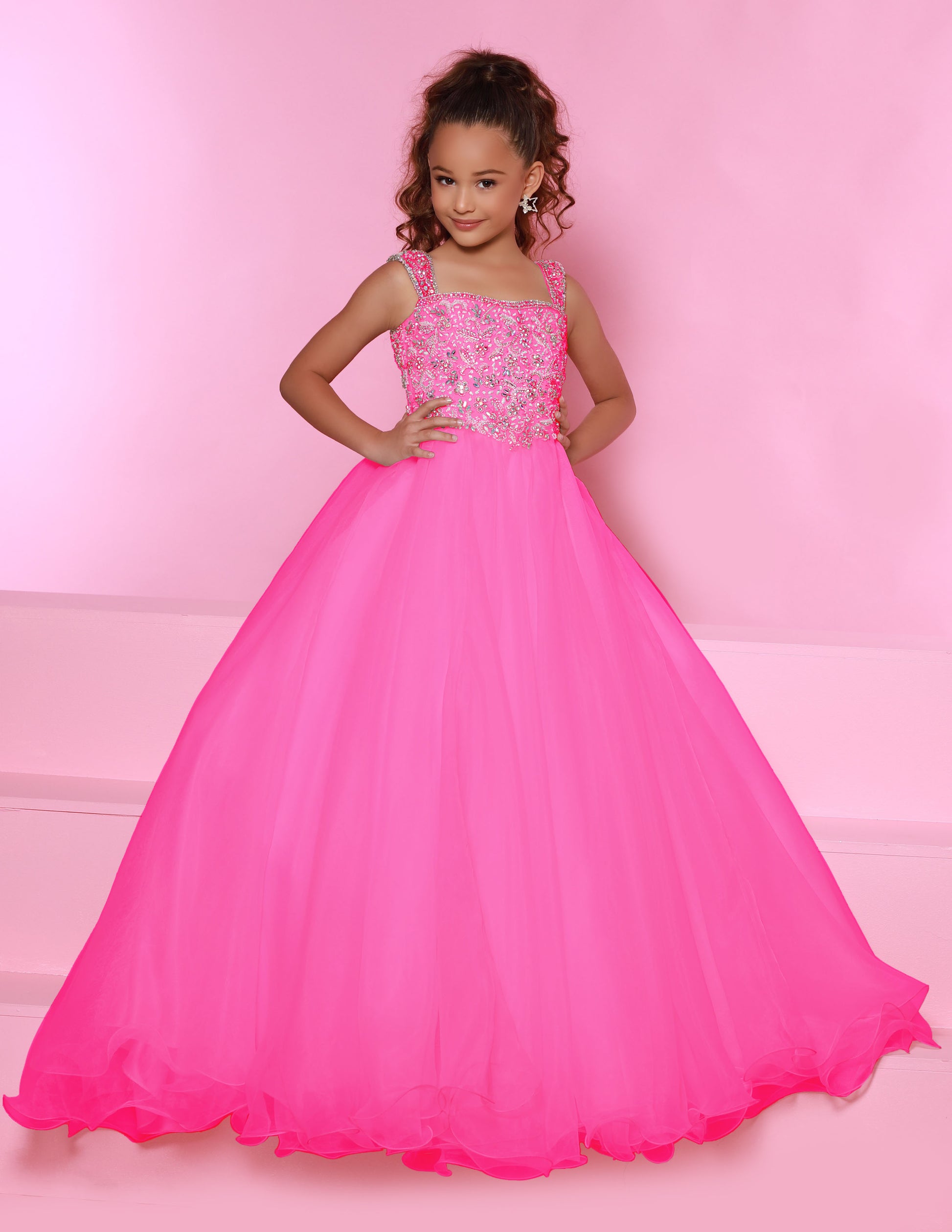 Sugar Kayne C146 Girls Pageant Dress.&nbsp; This lush pageant ballgown is made of flowy organza fabric.&nbsp; The top is embellished with semi sweetheart neckline and cap sleeves.&nbsp; Float on the stage in this full flowy pageant ballgown for girls and preteens.

Colors:&nbsp; Barbie Pink, Orange, Periwinkle, Royal, Turquoise, White

Sizes:&nbsp; 2-16

(Sizes 2-6 do not have bust cups, Sizes 8-16 will have preteen size bust cups)

Fabric:&nbsp; Organza, Mesh, Stretch Lining&nbsp;