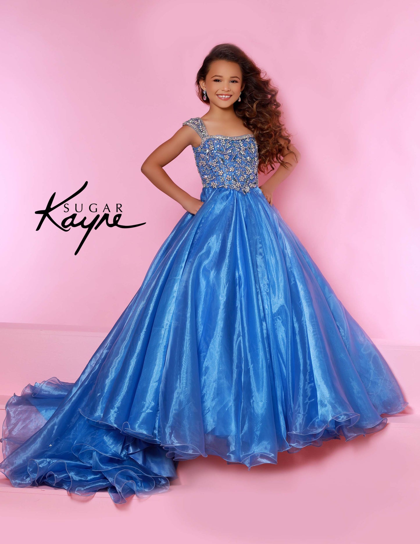 Sugar Kayne C146 Girls Pageant Dress.&nbsp; This lush pageant ballgown is made of flowy organza fabric.&nbsp; The top is embellished with semi sweetheart neckline and cap sleeves.&nbsp; Float on the stage in this full flowy pageant ballgown for girls and preteens.

Colors:&nbsp; Barbie Pink, Orange, Periwinkle, Royal, Turquoise, White

Sizes:&nbsp; 2-16

(Sizes 2-6 do not have bust cups, Sizes 8-16 will have preteen size bust cups)

Fabric:&nbsp; Organza, Mesh, Stretch Lining&nbsp;