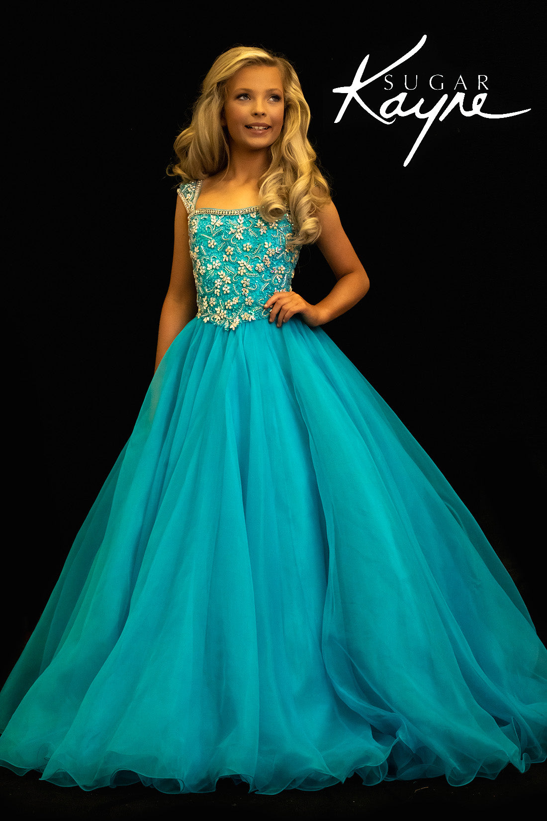 Sugar Kayne C146 Girls Pageant Dress.&nbsp; This lush pageant ballgown is made of flowy organza fabric.&nbsp; The top is embellished with semi sweetheart neckline and cap sleeves.&nbsp; Float on the stage in this full flowy pageant ballgown for girls and preteens.

Colors:&nbsp; Barbie Pink, Orange, Periwinkle, Royal, Turquoise, White

Sizes:&nbsp; 2-16

(Sizes 2-6 do not have bust cups, Sizes 8-16 will have preteen size bust cups)

Fabric:&nbsp; Organza, Mesh, Stretch Lining&nbsp;