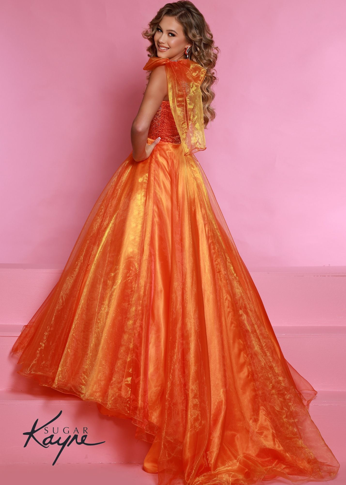Sugar Kayne C310 Girls and Preteens One Shoulder bodice with a Bow on the shoulder A Line Shimmer Pageant Dress Crystal Gown&nbsp;
Go ahead and take a BOW in this lovely one-shoulder organza ballgown. The ombre beaded bodice brings all the dazzle!

Colors:
Orange, Yellow, Blue, White, Neon Pink

Sizes:
2, 4, 6, 8, 10, 12, 14, 16

Fabric Organza, Mesh, Satin Lining

(Sizes 2-6 do not have bust cups, Sizes 8-16 will have preteen size bust cups)